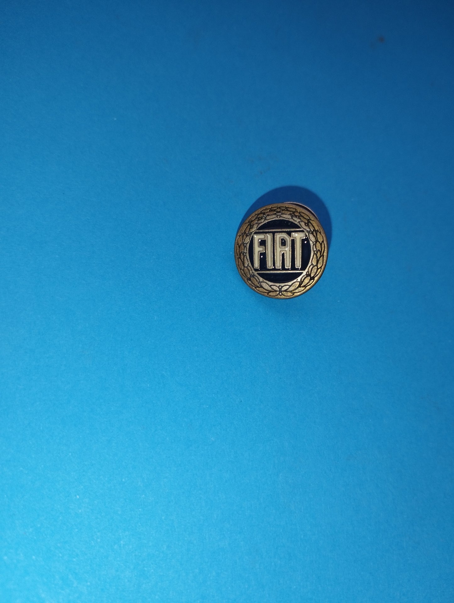 Fiat metal brooch