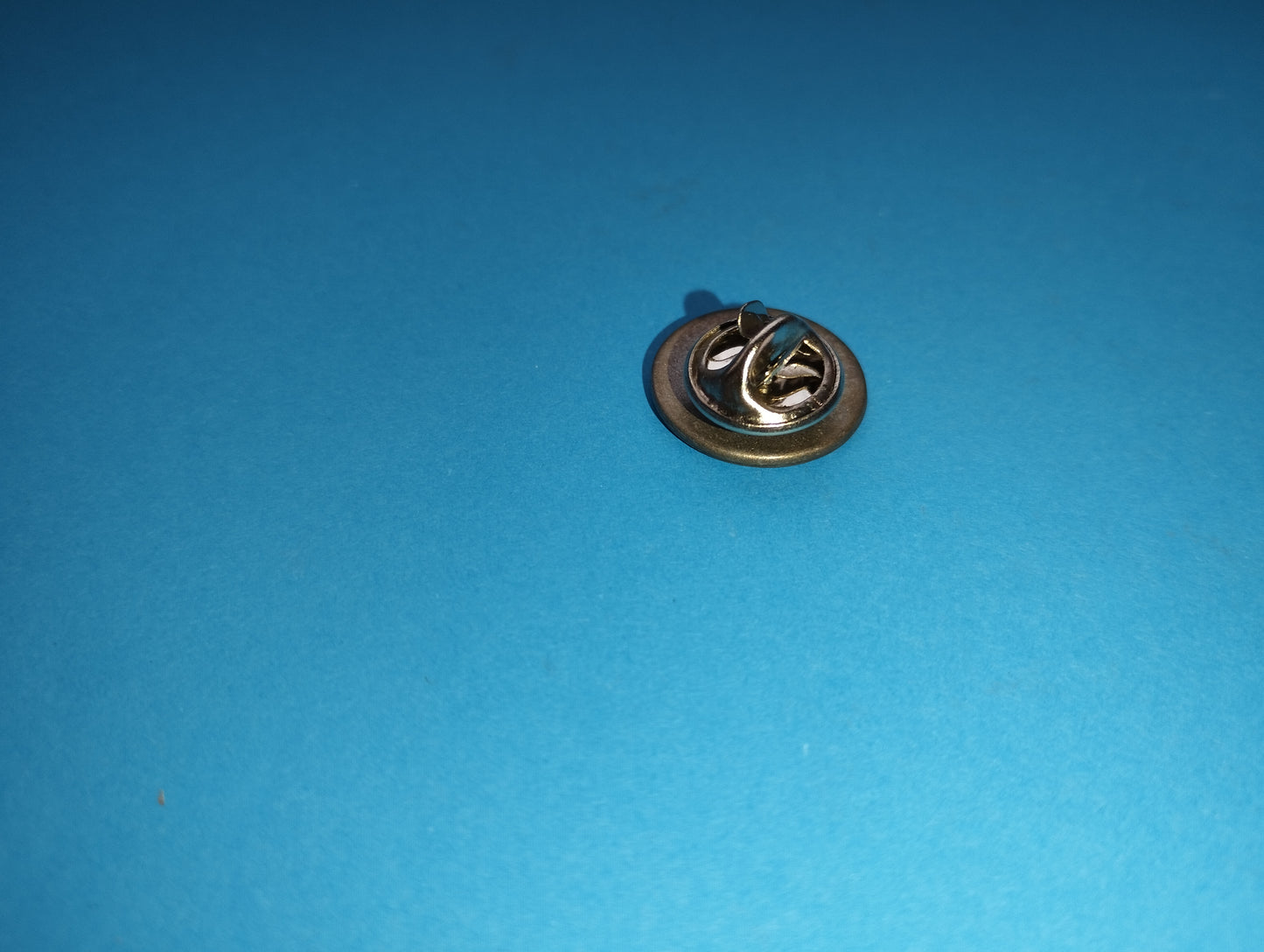 Fiat metal brooch