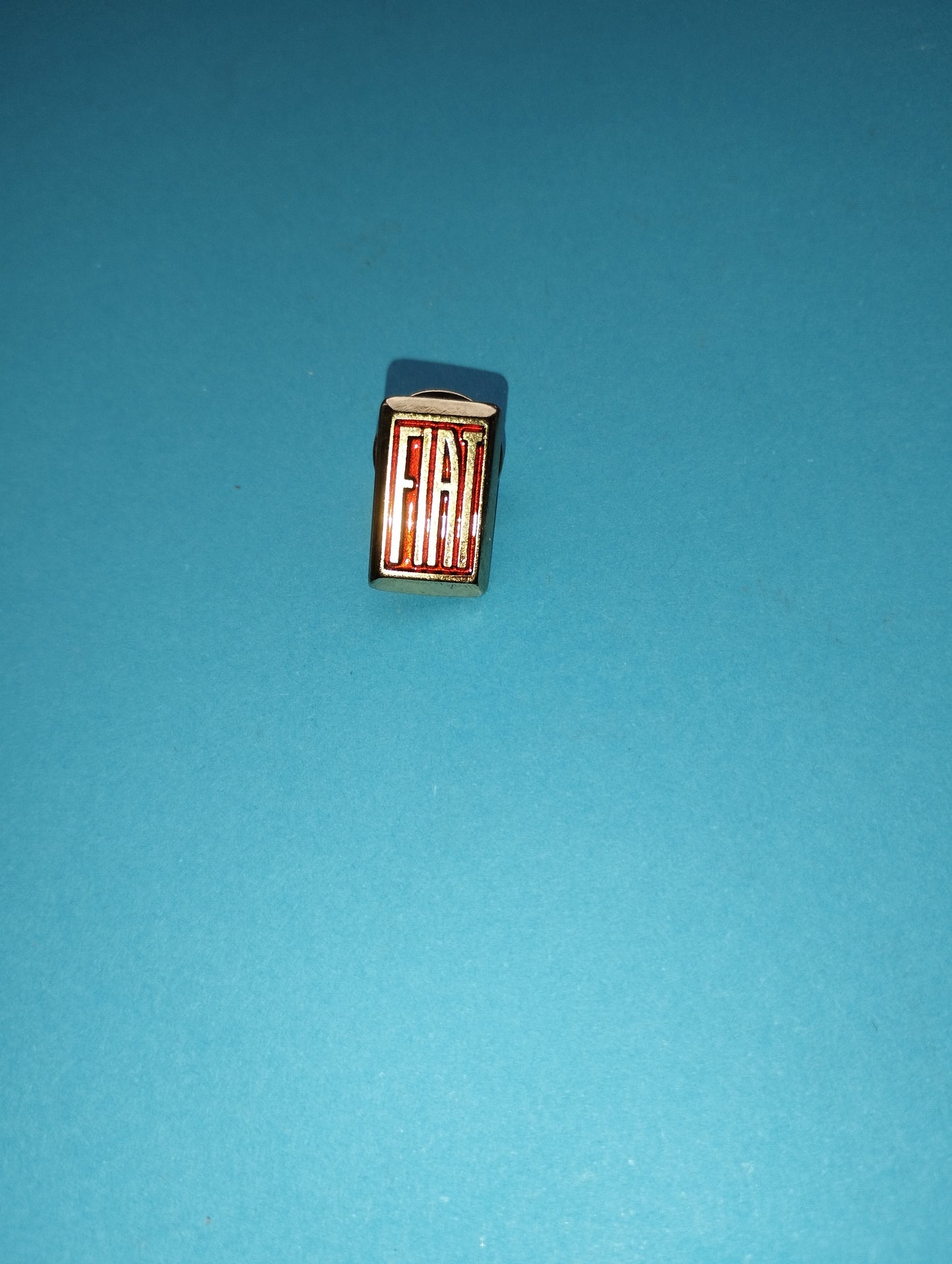 Fiat metal brooch