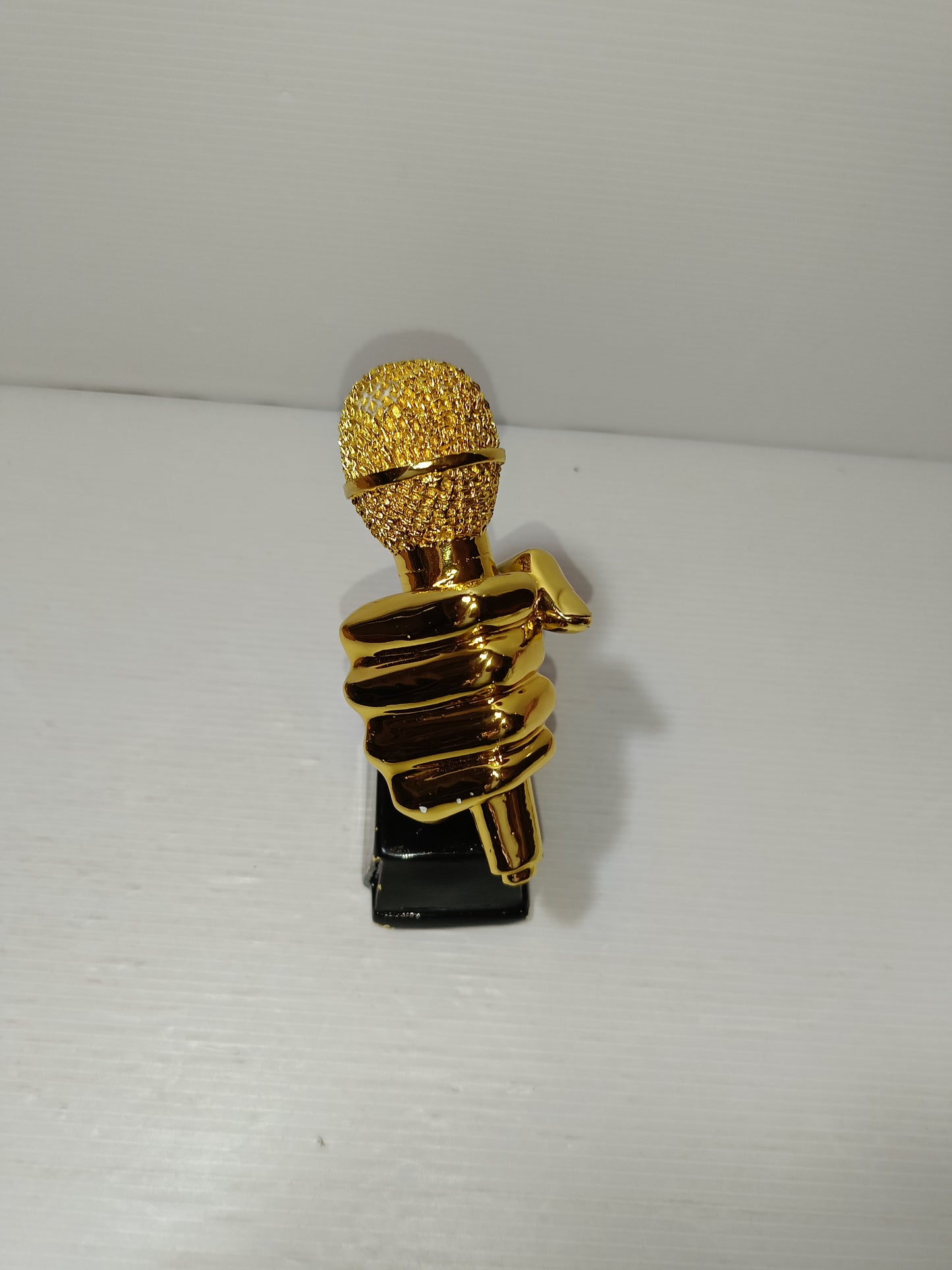 Scultura Mano Con Microfono Dorata
In resina