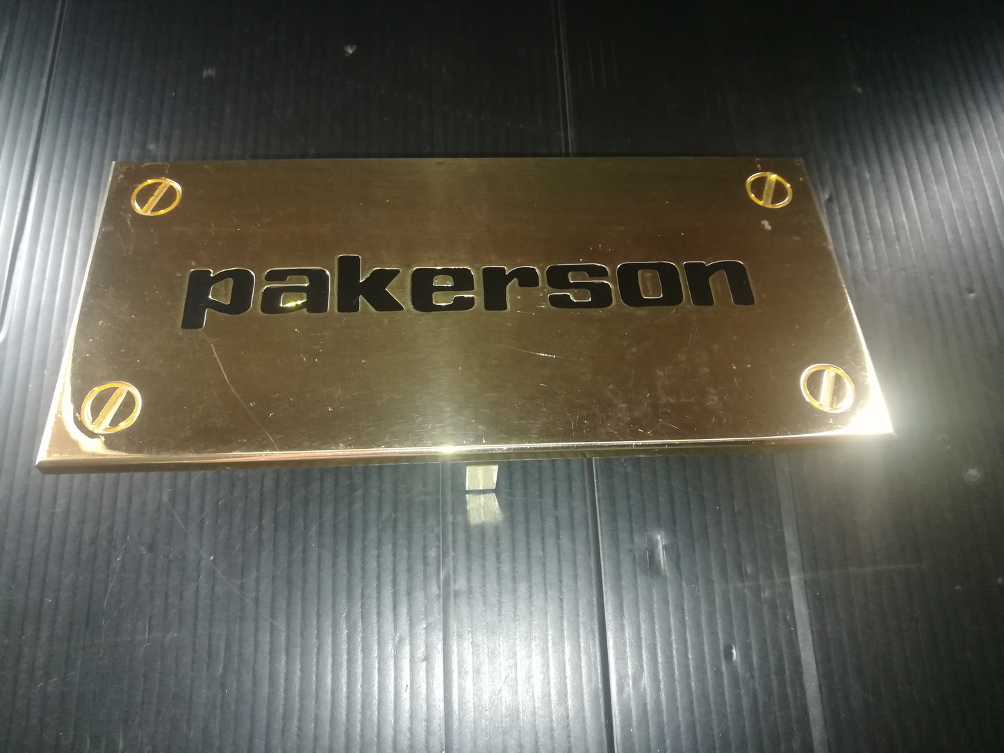 Pakerson Advertising Plaque In Golden Metal