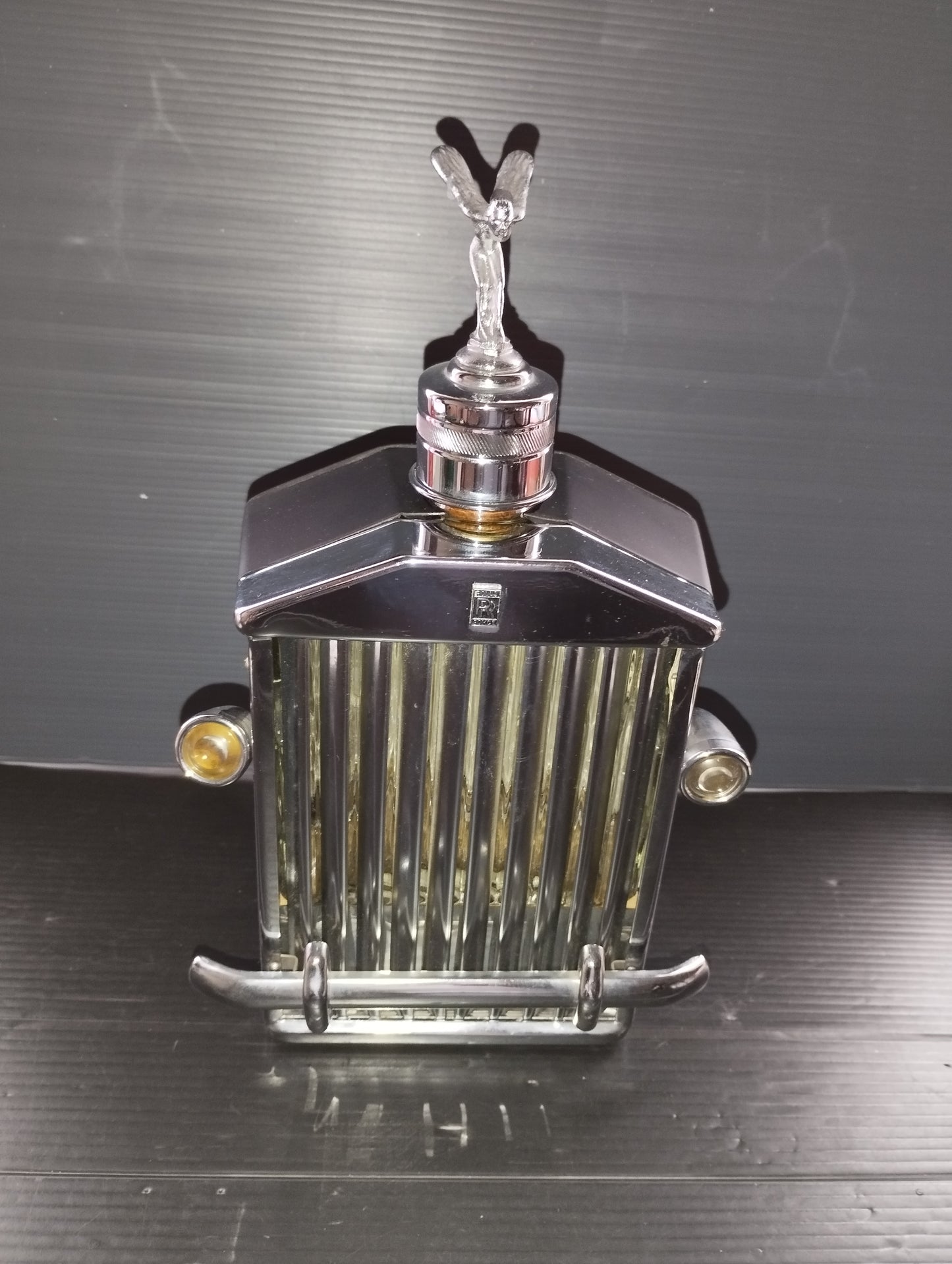 Bottle in the shape of a Rolls Royce Radiator with Music Box

 Original from the 60s